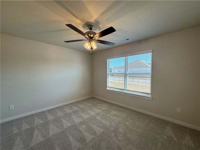 Escape to the cozy comfort of the secondary bedroom, a peaceful retreat with ample space to personalize and create your own haven. | Image 16