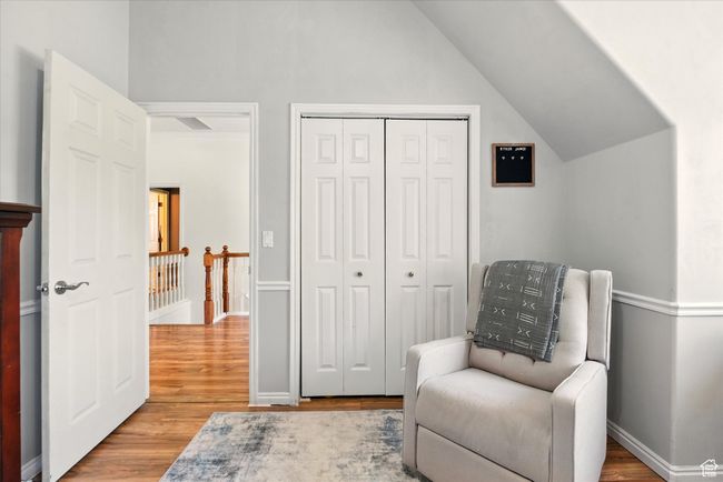 Sitting room featuring wood finished floors, lofted ceiling, an upstairs landing, and baseboards | Image 17