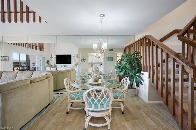 Dining area with an inviting chandelier and light hardwood / wood-style tile flooring | Image 5