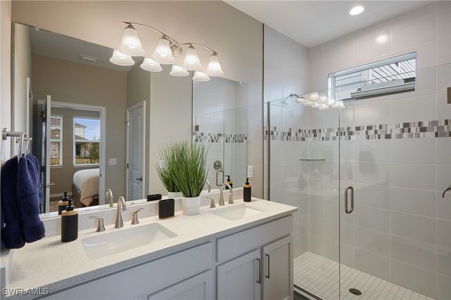 Full bathroom with double vanity, a stall shower, ensuite bath, and a sink | Image 10