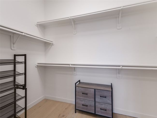 Spacious closet featuring light wood-style flooring | Image 15