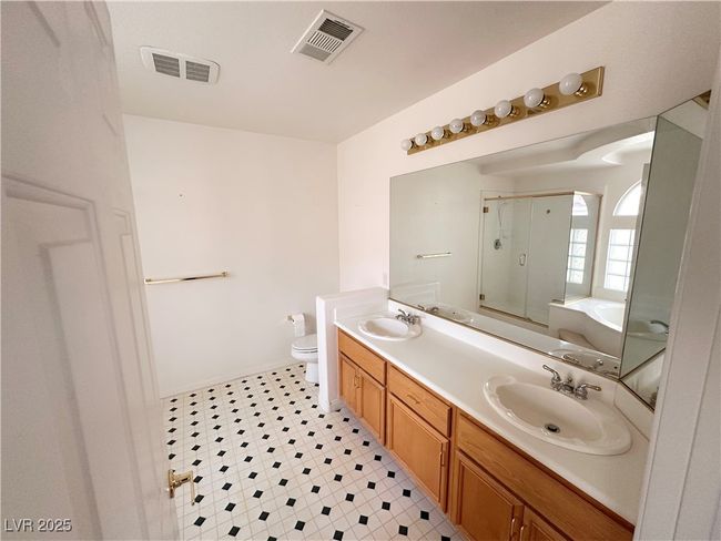 Full bathroom featuring a shower with door, toilet, a bathtub, double vanity, and tile patterned floors | Image 24