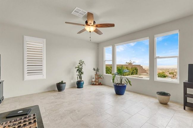 Living area with a ceiling fan | Image 16