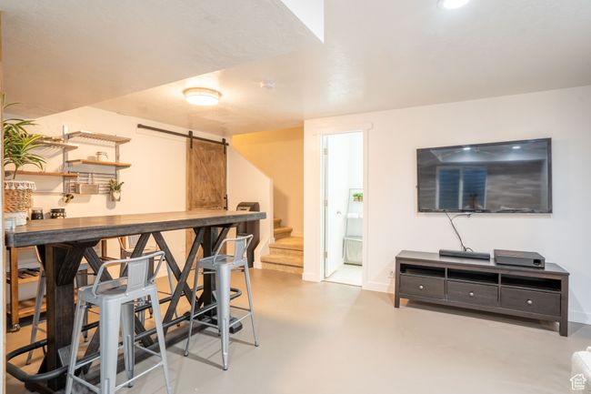 Bar area featuring a barn door to lots of storage, and stairway | Image 30
