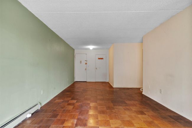 room with a baseboard heating unit and a textured ceiling | Image 9