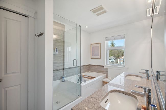 Bathroom featuring a shower stall, a garden tub, a sink, and visible vents | Image 19
