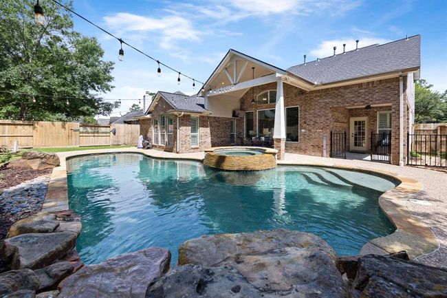 Secondary porch is located right off the back door, which is perfect for grilling or kiddos to play safely behind the gate. | Image 45