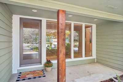 Front porch with large windows let in plenty of natural light. | Image 2