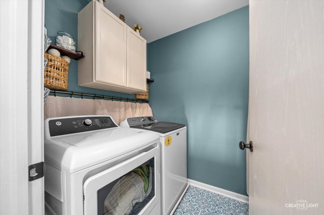Second floor laundry room with cabinets. | Image 21