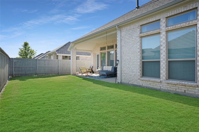 Fenced backyard with a patio | Image 22