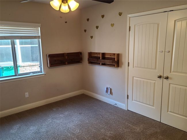 Unfurnished bedroom featuring carpet flooring and a closet | Image 22