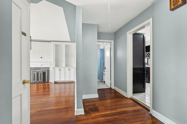 Corridor featuring baseboards and wood finished floors | Image 9