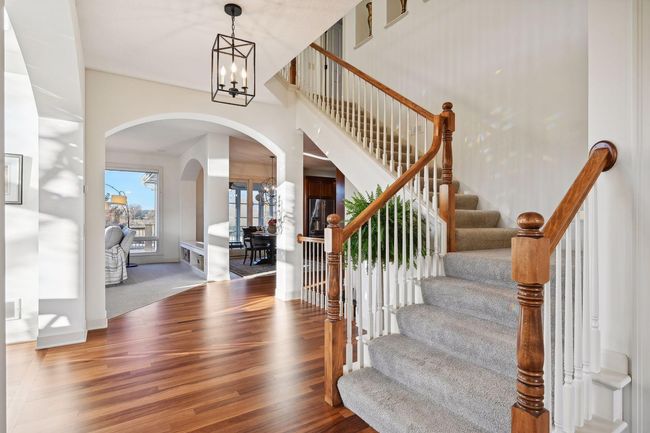 Staircase leads to upper level featuring four large bedrooms. | Image 32