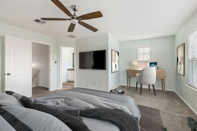 Carpeted bedroom featuring baseboards, a ceiling fan, and ensuite bath | Image 6