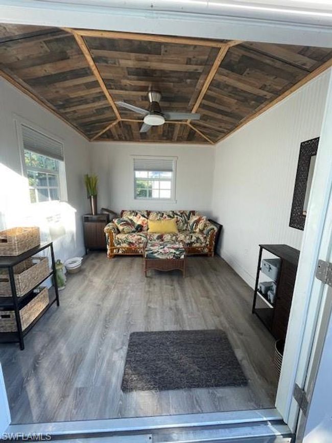 Living room featuring a wealth of natural light, wood ceiling, lofted ceiling, and wood-type flooring | Image 10