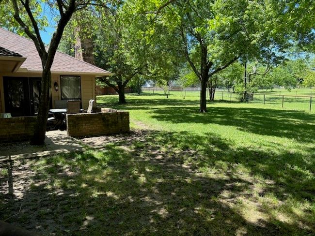 Fenced backyard featuring a patio | Image 26