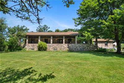 The front porch is a highlight and the perfect place to enjoy your private paradise. | Image 1