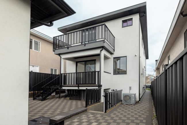 Rear view of property with a balcony, stucco siding, a patio area, and ac unit | Image 35