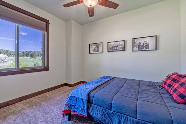 Bedroom featuring carpet floors, baseboards, and a ceiling fan | Image 37