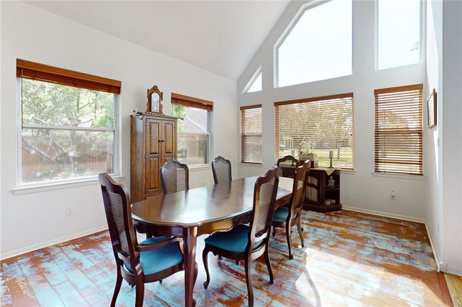 Dining space featuring vaulted ceiling, baseboards, and a wealth of natural light | Image 5