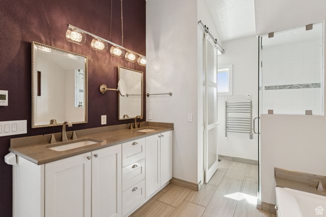 Full bath with double vanity, a bath, and a shower | Image 18