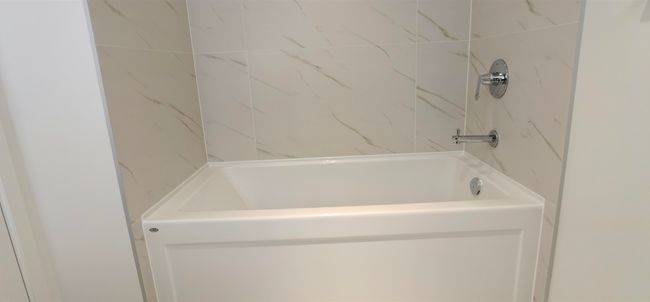 Full bathroom with a tub to relax in and a shower | Image 17