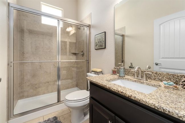 Full bathroom featuring vanity, toilet, tile patterned flooring, and a shower stall | Image 26