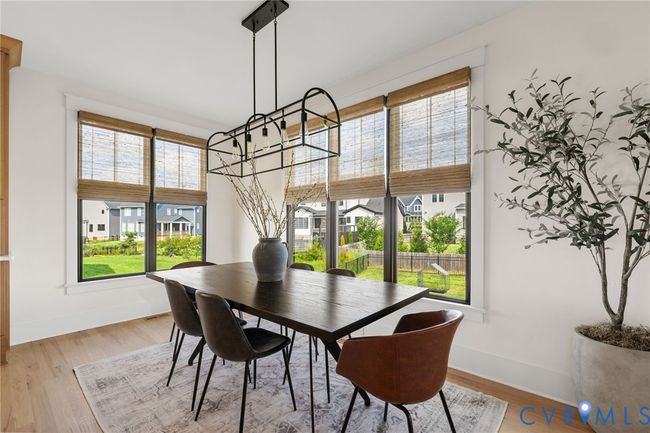 Dining area with light wood-style flooring and a chandelier | Image 17