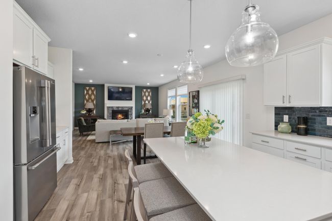 Photo is of the actual model. The kitchen overlooks the dining area and the great room. | Image 4