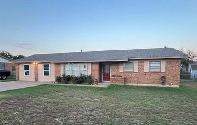 Ranch-style house featuring a yard | Image 1