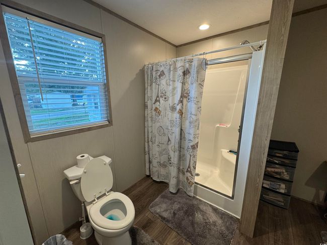 Full bath with a shower stall and wood finished floors | Image 12