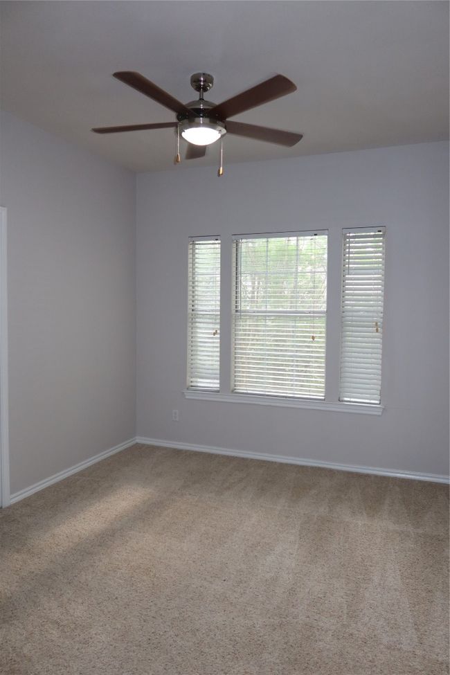 Spare room featuring a ceiling fan, carpet, healthy amount of natural light, and baseboards | Image 13