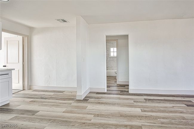 Empty room with light wood finished floors and baseboards | Image 9