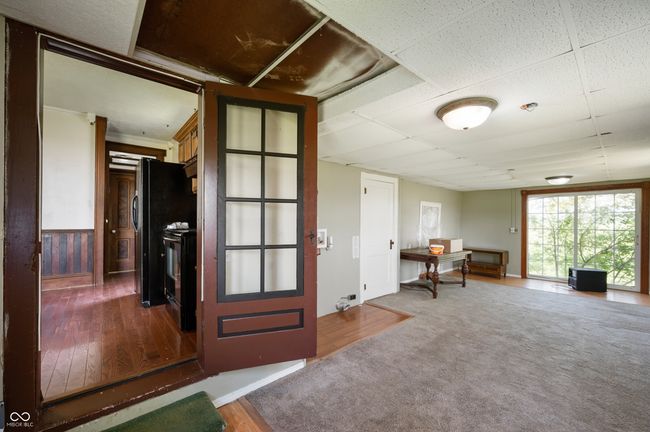 entryway featuring wood finished floors and baseboards | Image 9