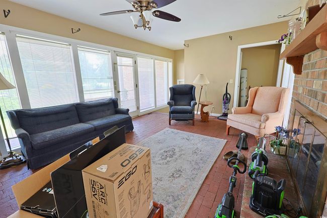 Living room featuring ceiling fan | Image 16