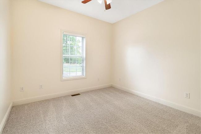 Carpeted spare room with visible vents, a ceiling fan, and baseboards | Image 23