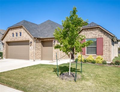 View of front of house featuring a garage and a front lawn | Image 1