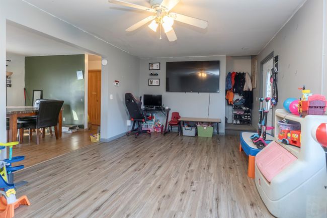 Living area featuring a ceiling fan and wood finished floors | Image 24