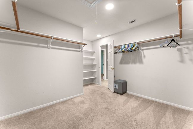 Walk in closet featuring carpet, attic access, and visible vents | Image 21