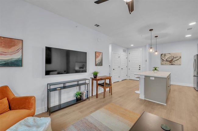 Living area featuring light wood-style flooring, recessed lighting, and a ceiling fan | Image 12