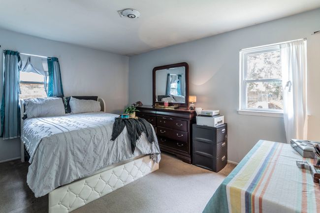 Bedroom featuring multiple windows and carpet with an en suite | Image 13