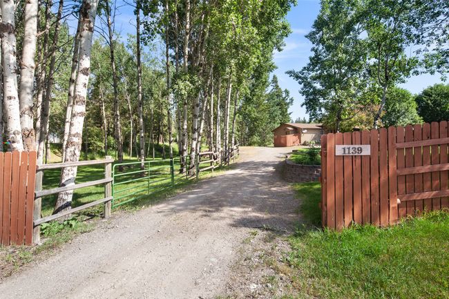 View of gravel driveway featuring a gate | Image 57
