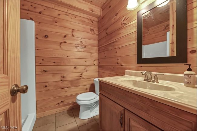 Lower level full bathroom with vanity, standalone shower, toilet and tile floor | Image 37