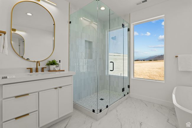 Full bathroom with a shower stall, vanity, light marble finish floors, a soaking tub, and recessed lighting | Image 6