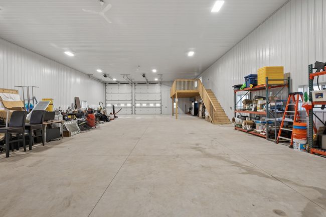 View of inside the outbuilding - three large garage doors (16 X 14), roughed-in plumbing for a bathroom, and a loft—ideal for any hobby or storage needs. | Image 28