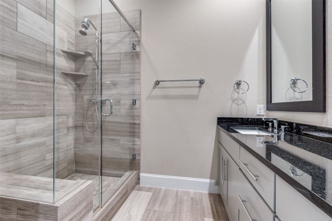Bathroom featuring a stall shower and vanity | Image 29