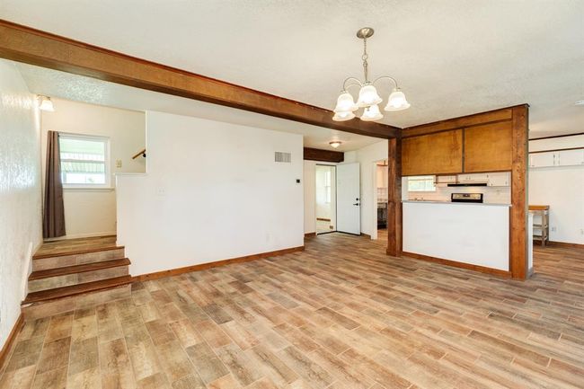 Dining Area is approximately 18' x 15'6". Buyer to verify all room measurements. The door to the left of the Kitchen goes to the 1st Floor Bedroom that is Virtually Staged as a Home Office in our photos. | Image 26