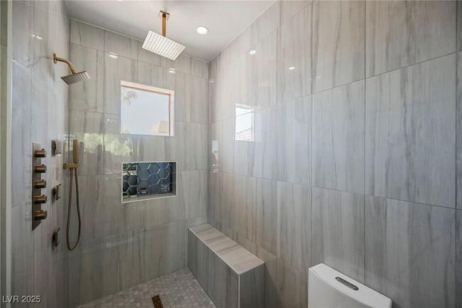 Bathroom with a tile shower and toilet | Image 58