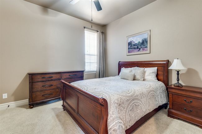 Bedroom featuring baseboards, light carpet, and ceiling fan | Image 28