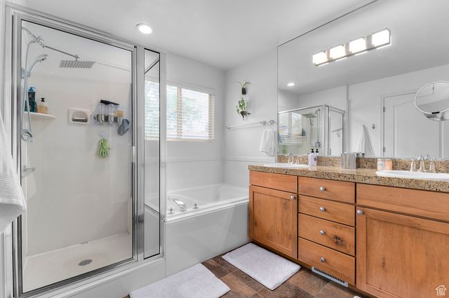 Owner's en suite Bathroom with double vanity, separate tub & shower and walk in closet. | Image 10